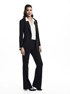 a woman in a black suit and white shirt