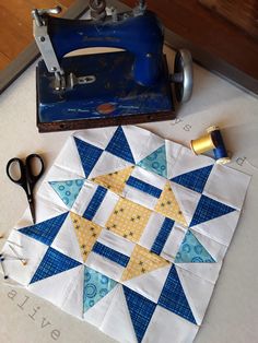 a quilter's block with scissors and sewing machine