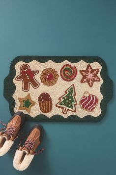 a pair of brown shoes sitting on top of a rug next to some christmas decorations