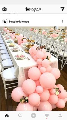 the table is set up with pink balloons