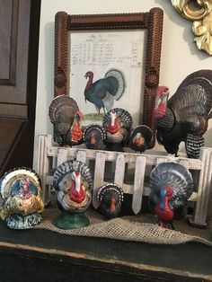 a group of turkeys sitting on top of a table next to a wooden frame