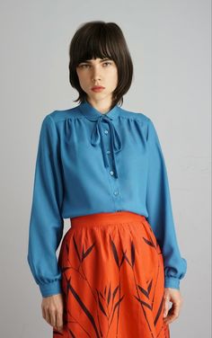 90s blue shirt, decorative neck and cuffs, bow in the neck. 100% Polyester ESTIMATED SIDE:  S, 36, 8 uk CONDITION: Very good Chest: 96 cm, 37'8 in Length: 67 cm, 26'4 in Shoulders: 37 cm, 14'6 in Sleeves length: 58 cm, 22'8 in Classic Blue Blouse For Fall, Chic Blue Tops With Bow, Chic Blue Top With Bow, Blue Tie Neck Top For Office, Blue Tie Neck Blouse For Work, Blue Tie Neck Blouse For Fall, Vintage Skirt Suit, 90s Shirts, Vintage Jacket