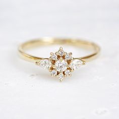 a gold ring with three diamonds on it