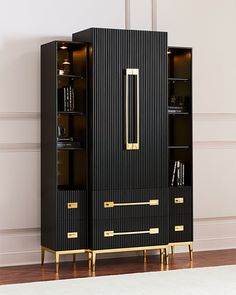 a tall black cabinet with gold trimmings on the door and shelves in front of it