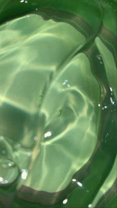 an image of water that is green and has some bubbles on the surface in it