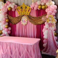 a pink and gold princess themed birthday party with balloons, streamers, table cloths, and decorations