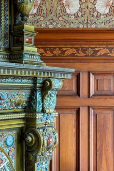 an ornate wooden door with intricate carvings on the front and back sides, along with decorative wood paneling