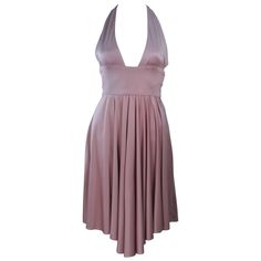 This Elizabeth Mason Couture gown is composed of a pink mauve silk jersey ('Blush' hue) and features a draped design. This halter style dress has a waist wrap. This effortlessly chic dress can be styled in a variety of fashions. Made in Beverly Hills. The gown may be fashioned in a variety of colors. This is a couture custom order. Please allow for a 60 day lead time from measurements, fabric selection, patterning, toile fitting, to final product. The dress shown is a sample size 2. The sample is not for purchase. Measurements of sample size: Length: 39" Bust: 14" Across Front Waist: 24" Hip: 44" Grey Cocktail Dress, Halter Cocktail Dress, Halter Style Dress, Couture Gown, Wrap Dresses, Pink Mauve, Dress Wrap, Dress Halter, Designer Drapes