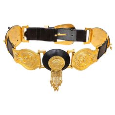 The Gianni Versace Medusa Bondage Belt is a coveted collector's item. Crafted from black leather, it features intricate medusa medallion appliqués and a bold gold metal buckle. A rare piece from the fall 1992 collection, it adds a touch of luxury to any outfit. Medusa Medallion, 1990s Fashion, Mohair Cardigan, Vintage Belts, Gianni Versace, Metal Buckles, Beautiful Fashion, Bling Bling, Luxury Jewelry