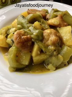 a white plate topped with green and yellow food