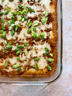 a casserole dish with cheese and green onions