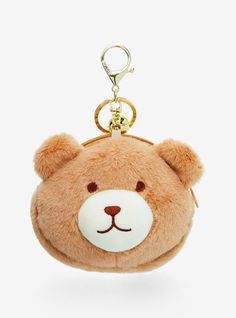 a brown teddy bear keychain with a white face on it's side