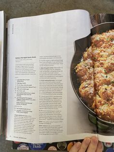 a cookbook opened to an image of food in a skillet on the table