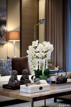 a living room filled with furniture and white flowers