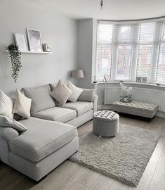 a living room filled with furniture and a large window