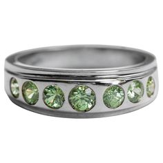 This 18K white gold band ring features 7 ¾ bright and fiery spring-green demantoid garnets that range in size from 3.4mm to 4.07mm and together weigh approximately 1.30 carats. This size 7 ring weighs 6.65 which is weighty for a size 7 ring. That weight is a sign of quality. And this ring was indeed made by an expert jeweler, who took great care to make sure the bezels holding each demantoid gemstone were burnished smooth. The only real design element is the ridge in the front that holds the garnets, offering just a subtle mound in profile. The demantoid garnet is one of the rarest and most valuable gemstones. Not only are they rare, they are almost always found in small carat sizes. It is a unique and lustrous gemstone characterized by its green hue and vivid dispersion that surpasses eve Ruby Band Ring, Georgian Ring, Ruby Bands, Demantoid Garnet, Rubellite Tourmaline, Carnelian Ring, Gold Band Ring, Garnet Stone, Tourmaline Ring