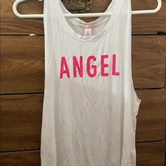 Selling Nwt Victoria’s Secret White “Angel” Tank Top. The Pictures Does Reflect Wrinkles But That Can Change When You Wash It And Hung Dry. Size L. White Tank With Pink “Angel” Screen Printed In The Chest Area. No Trades Or Paypal. Only Through The Poshmark App. Victoria's Secret White Stretch Top, Victoria's Secret Stretch White Top, Victoria's Secret White Top For Spring, Victoria's Secret Summer Tops With Letter Print, White Stretch Top By Victoria's Secret, Victoria's Secret Letter Print Summer Tops, Embroidered Cami Top, Pink Angel, White Angel