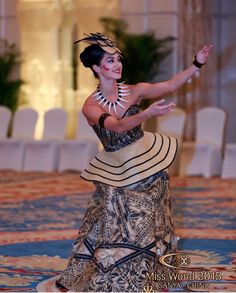 a woman in an elaborate dress is dancing