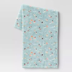 an image of a blue towel with small flowers and dots on the front, against a white background