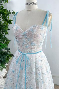 Elevate your style with our Corset Sky Blue 3D Floral Dress. The intricate floral design and removable tie straps add a touch of elegance to this dress. Perfect for any occasion, it will hug your curves and make you stand out. The ultimate luxury addition to your wardrobe. Bust and Skirt with full lining. 100% Polyester 100% Recycled polyester lining Concealed zip at center back Imported Blue Party Dress With Delicate Straps, Blue Dress With Adjustable Straps And Fitted Bodice, Blue Sleeveless Dress With Delicate Straps, Blue Dresses With Sweetheart Neckline And Straps, Blue Dress With Straps And Sweetheart Neckline, Blue Sweetheart Neckline Dress With Straps, Adjustable Straps Dresses For Wedding And Prom, Sweetheart Neckline Dresses With Tie Straps For Weddings, Wedding Dresses With Tie Straps And Sweetheart Neckline