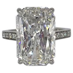 an engagement ring with a large diamond in the center and two rows of diamonds on each side