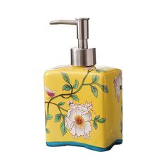 a yellow soap dispenser with flowers painted on it