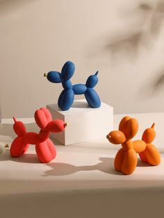 three small toy dogs sitting on top of a table