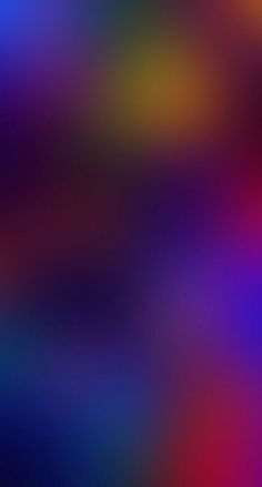 an abstract blurry background in blue, red, yellow and green colors is shown