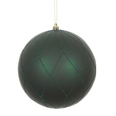 a green ball ornament hanging from a string