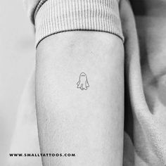 a small ghost tattoo on the arm