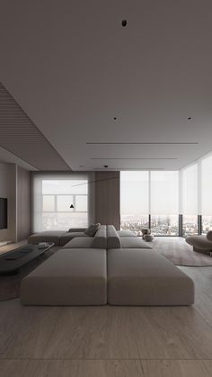 a large living room with white furniture and floor to ceiling windows