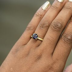 Indulge in the ethereal beauty of this 1.72ct round, color-shifting Songean sapphire! From purple-grey to teal blue depending on the light, this totally natural and ethically sourced gemstone will mesmerize. 7.3x4.51mm with some internal silk, visible from certain angles. Enjoy a timeless, elegant style with this stunning flat band 4-prong solitaire cast in 18k recycled yellow gold. The smooth, polished design measures 2mm wide for a classic yet modern look that's oh-so-comfortable to wear. Plus Luxury Solitaire Sapphire Jewelry, Luxury Sapphire Solitaire Jewelry, Timeless Sapphire Diamond Ring, Tanzanite Sapphire Ring With Prong Setting, Timeless Round Sapphire Ring, Sapphire Colored Moissanite Ring, Round Moissanite Sapphire Ring, Blue Tanzanite Round Jewelry, Blue Round Tanzanite Jewelry