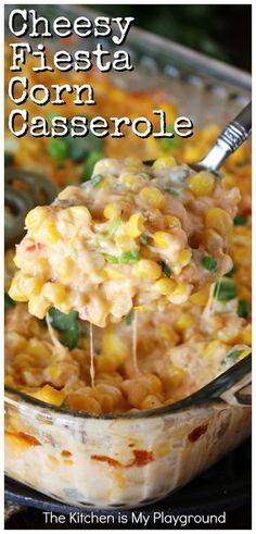 cheesy fiesta corn casserole in a glass dish with a spoon