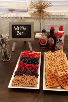 two white plates topped with waffles and fruit