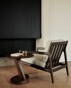 a chair and table in front of a fireplace