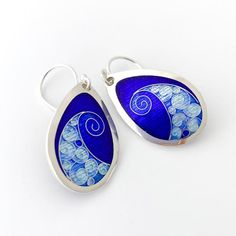 VIVID Cobalt Blue Wave Dangle Earrings – Cloisonné & Champlevé Glass Enamels on Fine Silver w/ Sterling Ear Wires by Sandra McEwen DesignsThese teardrop shaped earrings feature a bold silver wave framed in electric shades of blue.Materials: Champlevé & cloisonné Enamels on Fine silver.EarringsSize: 1” long x .6” wide ------------------------------------------------------------------------------------------------Did you know that enamels are melted glass?  Yes!  It's true...  To create th Metal Clay Jewelry, Wrist Jewelry, Enamels, Metal Clay, Blue Waves, Enamel Jewelry, Gorgeous Jewelry, Silver Wire, Fine Silver