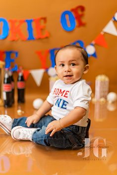 a baby is sitting on the floor in front of some decorations