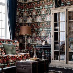 a living room filled with furniture next to a window