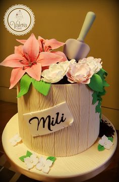 there is a cake decorated with flowers and a sign on it that says mii