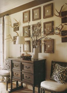 a living room filled with lots of furniture and pictures on the wall above it's dresser