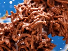 there is a pile of chocolate pretzels on top of each other in front of snowflakes