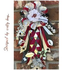 a football wreath hanging on the side of a brick wall