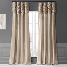 a curtain with ruffles hanging on the side of it in front of a window