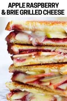 a stack of grilled sandwiches sitting on top of a wooden table