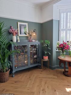 a living room filled with furniture and lots of plants