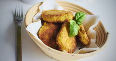 a bowl filled with fried food next to a fork