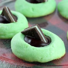 some green doughnuts with chocolate on top