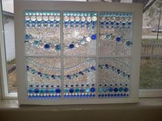 a window that has some glass beads on it