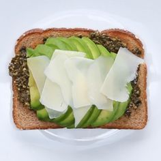 a piece of bread with cheese and vegetables on it