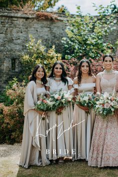 the bride and her bridesmaids pose for a photo